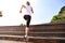 Sports woman running up on wooden stairs