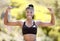 Sports woman with strong biceps doing exercise and training. Portrait of young black woman showing strength, fitness and