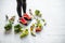 Sports woman weighing with healthy food around