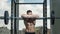 Sportsman, athlete with muscles looks attractive. Man with torso, muscular macho lean on barbell, window on background