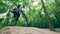 Sportsman on a bicycle is jumping over a ramp in the forest