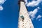 Sportsman climber training outdoor with blue sky , climbing on artificial colourful rock wall. Healthy lifestyle and