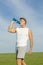 Sportsman drinking from water bottle.