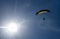 The sportsman flying on a paraglider. Paragliding Silhouette on blue sky. Paragliding take off. Travel destination