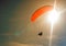 The sportsman flying on a paraglider. Paragliding Silhouette on blue sky. Paragliding take off. Travel destination