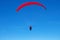 The sportsman flying on a paraglider. Paragliding Silhouette on blue sky. Paragliding take off. Travel destination