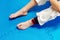 The sportsman foot in a kimono sits on a blue background after a workout