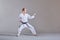 Sportsman in karategi and with a black belt does formal karate exercises