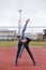 Sportsman makes exercises on a running track