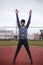 Sportsman makes exercises on a running track