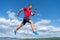 sportsman man runner run to success or jump high on sky background, sport