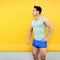 Sportsman over colorful yellow wall background. Fitness, sport concept, looks profile