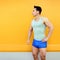 Sportsman posing over colorful yellow wall background. Fitness, sport concept, looking profile