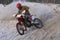 Sportsman racer man fulfills a fast ride on a motorcycle on the road extreme. The race track is very uneven. Photo as the racer p