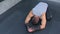 Sportsman resting on mat after using trainer for myofascial stretching in gym.