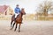 Sportsman riding horse on equestrian training.