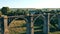 Sportsman is running along an old massive bridge