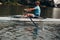 Sportsman single scull man rower rowing on boat