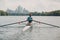 Sportsman single scull man rower rowing on boat