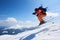 Sportsman skier jumping in air down steep snowy mountain slope on copy space background of blue sky.