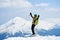 Sportsman skier on skis on background of blue sky and highland landscape. Winter skiing concept.