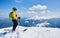 Sportsman skier on skis on background of blue sky and highland landscape. Winter skiing concept.