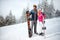 Sportsman and sportswoman on skiing holding ski equipment