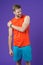 Sportsman touch shoulder on violet background. Muscular man feel pain after training or workout. Pain in shoulder. Sport