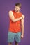 Sportsman touch shoulder on violet background. Muscular man feel pain after training or workout. Pain in shoulder. Sport