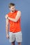 Sportsman touch shoulder on violet background. Muscular man feel pain after training or workout. Pain in shoulder. Sport