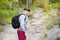 sportsman walking with a black backpack after finishing the workout in nature