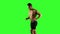 Sportsman walks and runs on a treadmill. Green screen studio