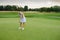 Sportsman Woman Tries Put Ball Into Golf Hole .