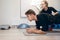 Sportsman working out on the floor with personal coach