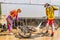 Sportsmen bikers cleanse bicycles with high pressure washing outfit. Mountain biking in terrain bike park. Bike maintenance
