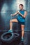 Sportsmen. fit malestands with one foot on the tire iron chain and tears , concept crossfit fitness workout strenght power