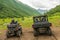 Sportsmen in helmets drive ATV and SSV in Caucasus mountains. Quad bike and buggy travel adventure and nature exploration concept