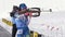 Sportswoman biathlete aiming, rifle shooting in standing position. Khanty-Mansiysk biathlete Khairulina Elena in