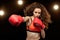 Sportswoman boxer training and punching