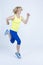 Sportswoman Concepts. Running Mature Sportswoman During Active Jogging Training  Against White Background