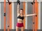 Sportswoman doing dumbbell push press exercise