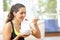 Sportswoman eating cereals after sport at home