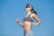 Sportswoman jogging on background of clear sky