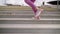 sportswoman is jumping over stairs, training legs muscles, closeup of feet