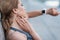 Sportswoman measuring pulse with smartwatches