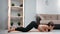 Sportswoman performing stretching training lifting flexible body spine enjoy domestic workout