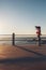 Sportswoman running on a road by the sea