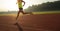 sportswoman running on sunrise track
