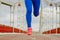 Sportswoman runs on the bridge, legs in sneakers close-up.