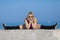 Sportswoman in sunglasses doing exercises on concrete wall